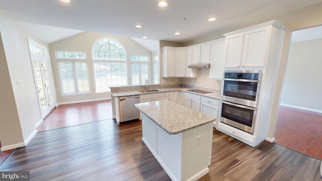8117 Grayden Ln, Brandywine, MD 20613 - kitchen with appliances with stainless steel finishes, a kitchen island, dark wood-style floors, light stone countertops, and white cabinetry