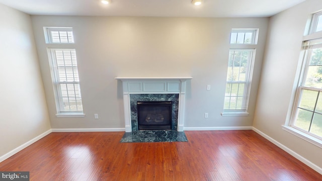 8117 Grayden Ln, Brandywine, MD 20613 - unfurnished living room with plenty of natural light, wood finished floors, a high end fireplace, and recessed lighting