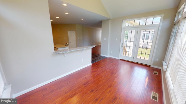 8117 Grayden Ln, Brandywine, MD 20613 - unfurnished living room featuring plenty of natural light, dark wood-style floors, recessed lighting, and lofted ceiling