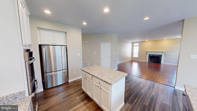 8117 Grayden Ln, Brandywine, MD 20613 - kitchen featuring freestanding refrigerator, dark wood-style floors, white cabinets, a center island, and recessed lighting