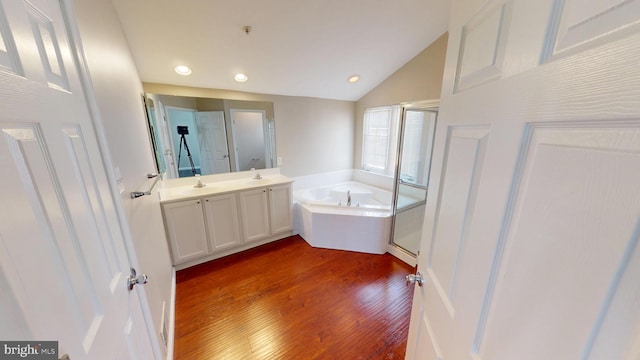 8117 Grayden Ln, Brandywine, MD 20613 - bathroom featuring a bath, wood finished floors, vanity, vaulted ceiling, and recessed lighting