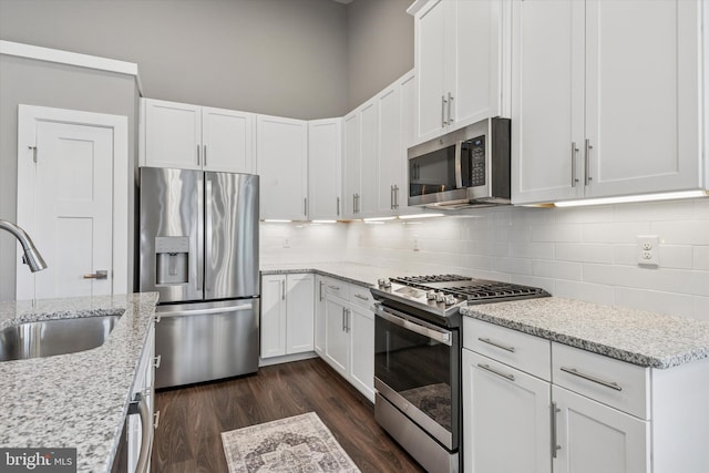 294 Letitia Manor Dr, West Grove, PA 19390 - kitchen featuring appliances with stainless steel finishes, decorative backsplash, white cabinetry, and dark wood-style flooring