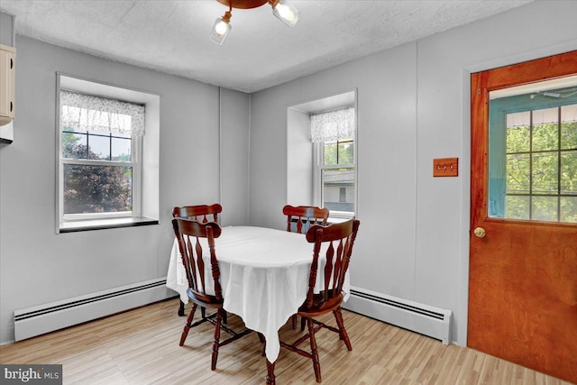 1124 Fairview Dr, Reading, PA 19605 - dining space with baseboard heating, healthy amount of natural light, light wood finished floors, and a textured ceiling