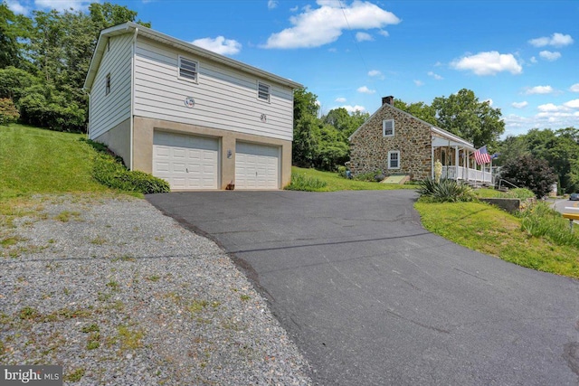 1124 Fairview Dr, Reading, PA 19605 - view of front facade featuring a front yard, asphalt driveway, and a garage