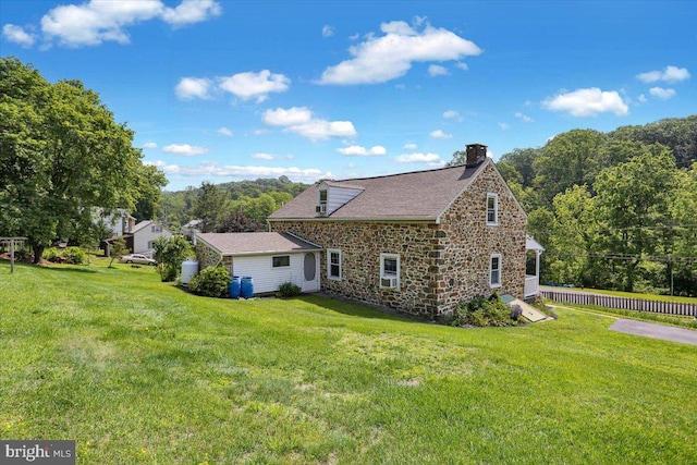1124 Fairview Dr, Reading, PA 19605 - view of home's exterior with stone siding, a chimney, a yard, and roof with shingles