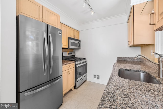 1516 Berwick Rd, Baltimore, MD 21204 - kitchen with appliances with stainless steel finishes, light brown cabinets, ornamental molding, rail lighting, and dark stone counters