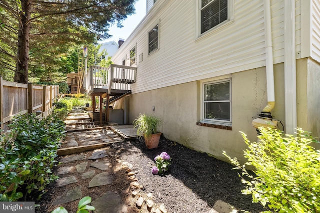 1516 Berwick Rd, Baltimore, MD 21204 - view of home's exterior with a wooden deck, stucco siding, a patio area, and stairs