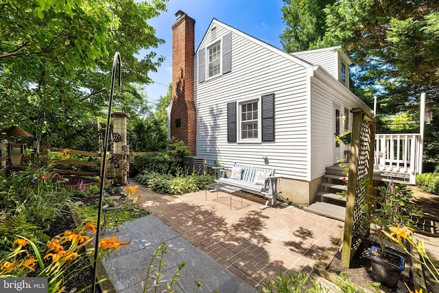 1516 Berwick Rd, Baltimore, MD 21204 - rear view of house with a chimney, a patio area, and a wooden deck