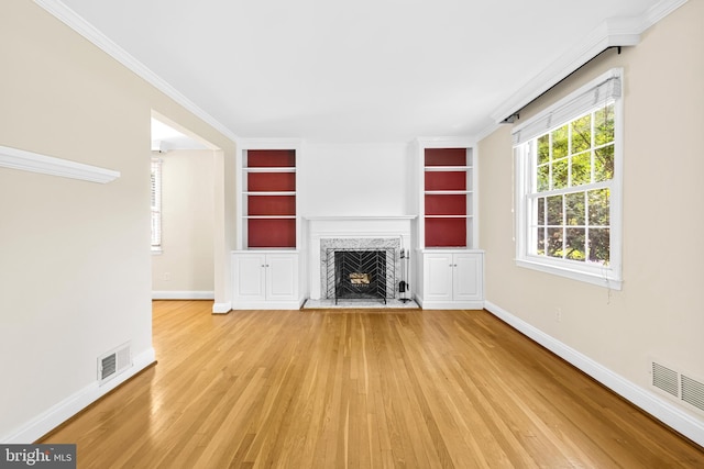 1516 Berwick Rd, Baltimore, MD 21204 - unfurnished living room featuring wood finished floors, built in features, a high end fireplace, and crown molding