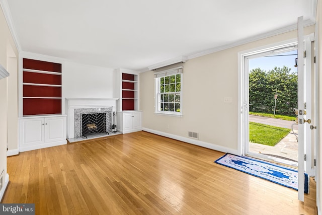 1516 Berwick Rd, Baltimore, MD 21204 - unfurnished living room featuring hardwood / wood-style flooring, a high end fireplace, crown molding, and built in features