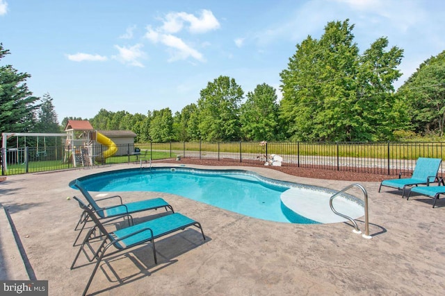 148 S Allwood Dr, Hanover, PA 17331 - view of swimming pool featuring a patio, a playground, and view of wooded area