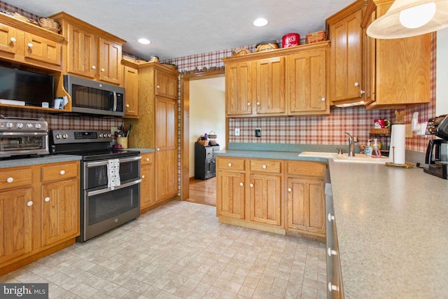 148 S Allwood Dr, Hanover, PA 17331 - kitchen featuring stainless steel appliances, tasteful backsplash, light countertops, brown cabinets, and recessed lighting