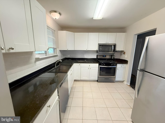 433 Edsam Ave, Pitman, NJ 08071 - kitchen featuring appliances with stainless steel finishes, white cabinets, light tile patterned floors, and tasteful backsplash