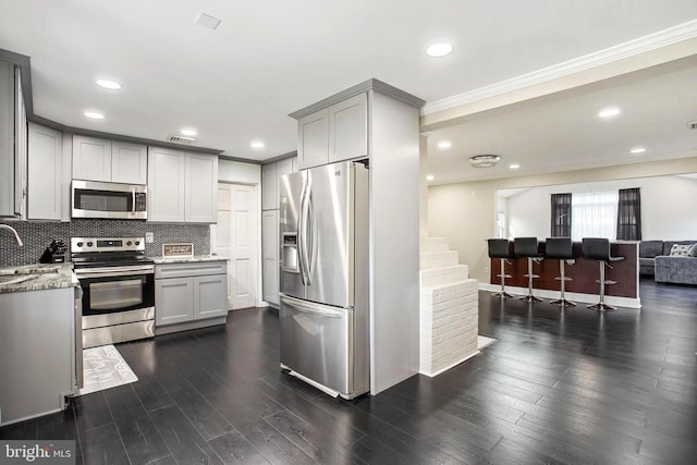 37 Outlook Ln, Levittown, PA 19055 - kitchen featuring stainless steel appliances, gray cabinets, backsplash, dark wood-type flooring, and ornamental molding