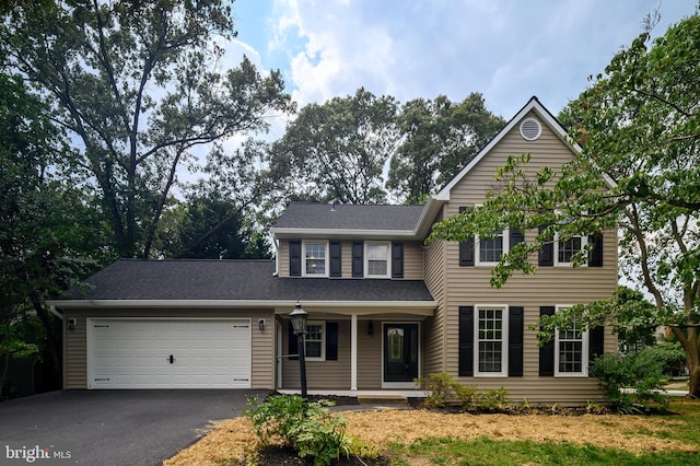 320 Redwood Grove Ct, Millersville, MD 21108 - view of front facade featuring driveway, an attached garage, and covered porch