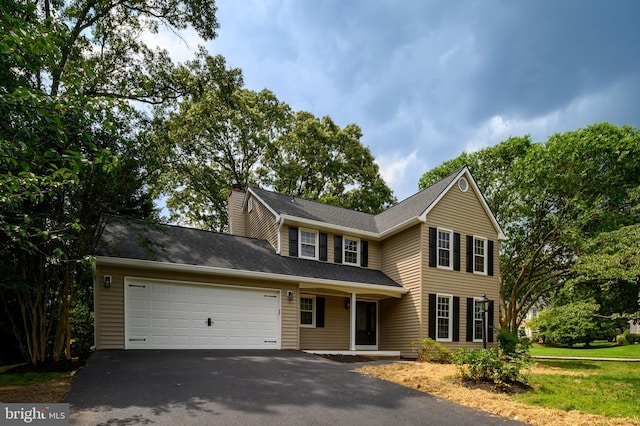 320 Redwood Grove Ct, Millersville, MD 21108 - view of front of house featuring driveway, a garage, and a chimney