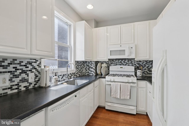 929 S 18th St, Philadelphia, PA 19146 - kitchen featuring white appliances, dark countertops, white cabinetry, backsplash, and recessed lighting