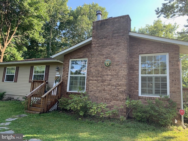 251 Kelly Dr, Harpers Ferry, WV 25425 - view of front of home with a front lawn and a chimney