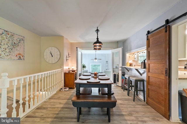 251 Kelly Dr, Harpers Ferry, WV 25425 - dining room with wood finished floors, a barn door, and ceiling fan