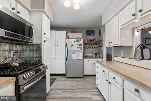 251 Kelly Dr, Harpers Ferry, WV 25425 - kitchen featuring stainless steel appliances, light countertops, decorative backsplash, and white cabinets