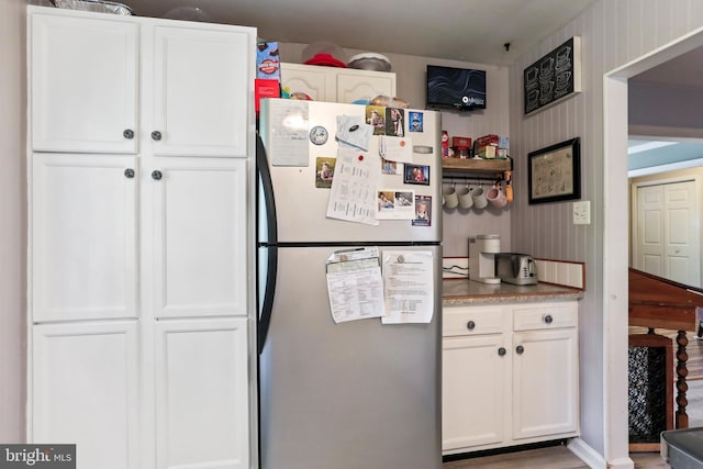 251 Kelly Dr, Harpers Ferry, WV 25425 - kitchen with freestanding refrigerator, white cabinetry, and light countertops