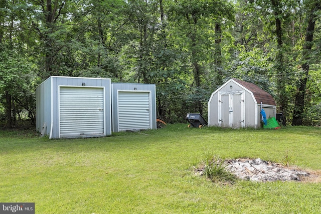 251 Kelly Dr, Harpers Ferry, WV 25425 - view of green lawn with a storage unit and a wooded view