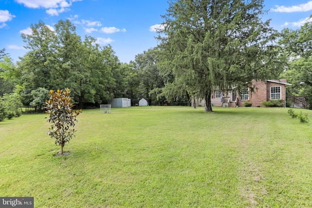 251 Kelly Dr, Harpers Ferry, WV 25425 - view of grassy yard featuring a storage unit