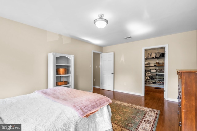 15321 Peach Orchard Rd, Silver Spring, MD 20905 - bedroom featuring dark wood-style flooring, a walk in closet, and a closet