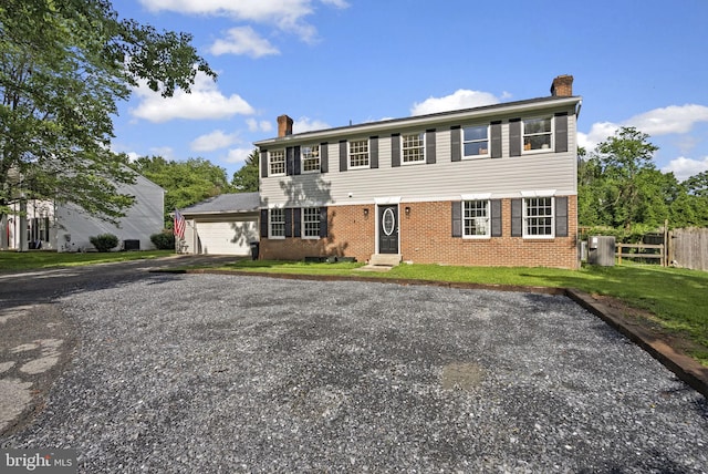 15321 Peach Orchard Rd, Silver Spring, MD 20905 - colonial home featuring a chimney, brick siding, and a garage