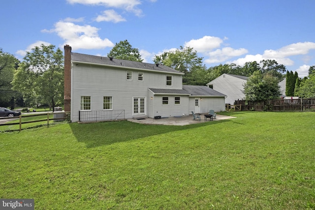 15321 Peach Orchard Rd, Silver Spring, MD 20905 - rear view of house with a chimney, a patio, french doors, and a fenced backyard