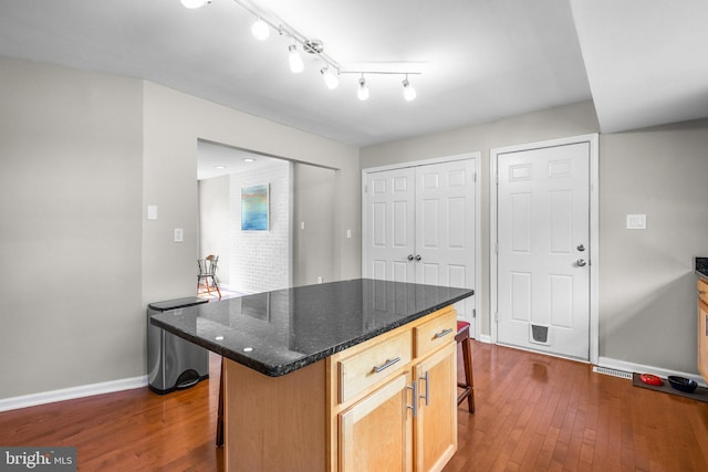 15321 Peach Orchard Rd, Silver Spring, MD 20905 - kitchen featuring a kitchen bar, dark wood-style flooring, and a kitchen island