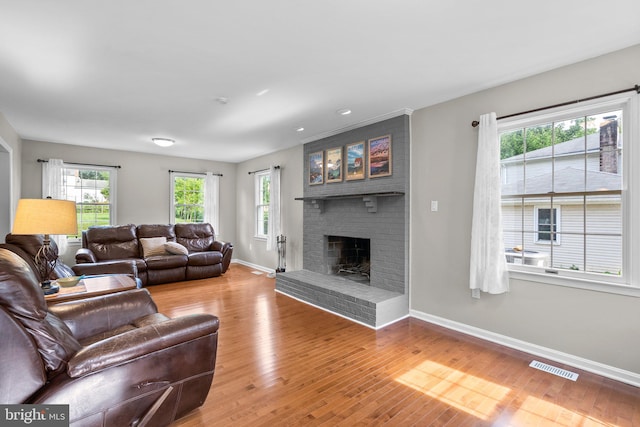 15321 Peach Orchard Rd, Silver Spring, MD 20905 - living area with a brick fireplace, wood finished floors, and recessed lighting