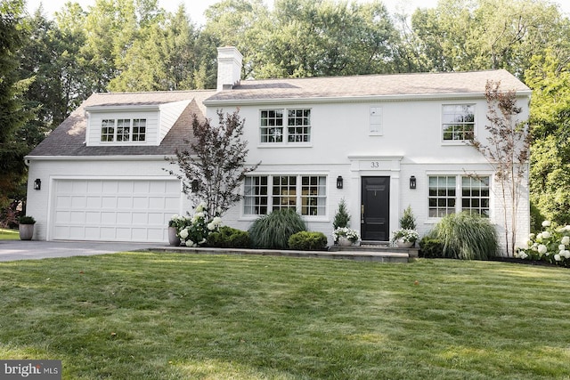 33 Conestoga Blvd, Lancaster, PA 17602 - view of front of house with a front lawn, a chimney, a garage, driveway, and roof with shingles