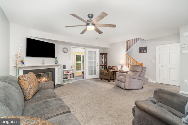 1866 Wexford Rd, Palmyra, PA 17078 - carpeted living room with ceiling fan, stairway, and a fireplace with flush hearth