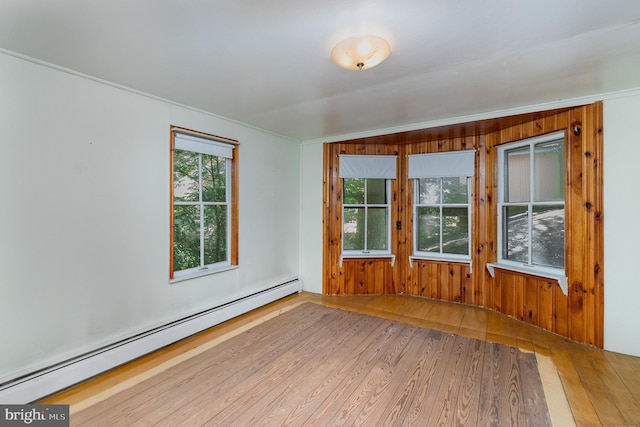 505 7th St, Mount Gretna, PA 17064 - empty room with a baseboard heating unit, wood finished floors, and wood walls