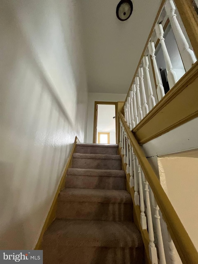 706 W Butler St, Philadelphia, PA 19140 - stairs with baseboards and carpet