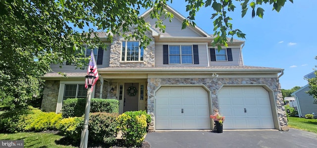 15 Limestone Ct, Lititz, PA 17543 - view of front of house with stone siding, driveway, and a garage