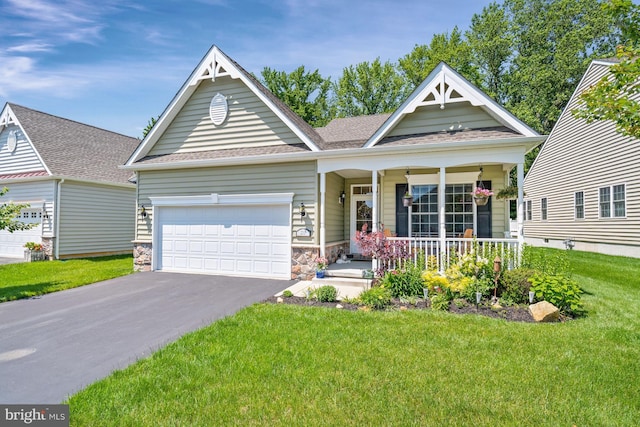 231 Lupine Dr, Smyrna, DE 19977 - view of front facade with a porch, asphalt driveway, a front yard, a garage, and a shingled roof