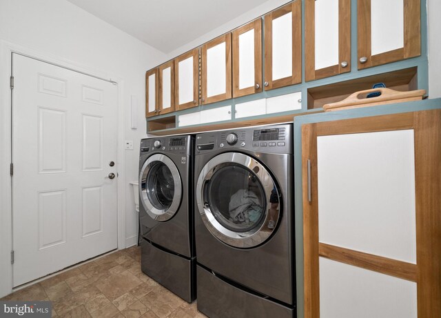 231 Lupine Dr, Smyrna, DE 19977 - laundry room with washing machine and clothes dryer, cabinet space, and stone finish flooring