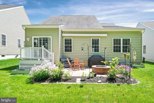 231 Lupine Dr, Smyrna, DE 19977 - back of house featuring a fire pit, a lawn, a patio, and roof with shingles