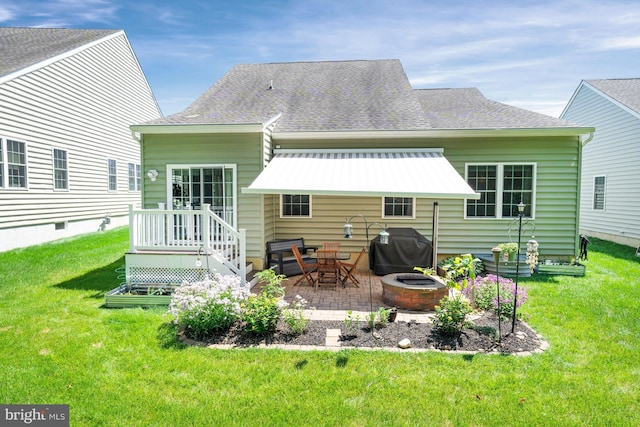 231 Lupine Dr, Smyrna, DE 19977 - back of house featuring a fire pit, a patio area, a lawn, and a shingled roof