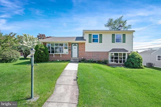 411 Parkstone Way, Broomall, PA 19008 - tri-level home featuring brick siding, a front lawn, and a chimney