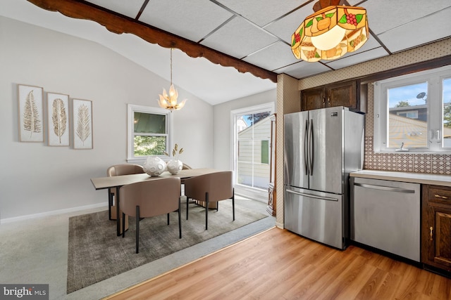 411 Parkstone Way, Broomall, PA 19008 - kitchen featuring stainless steel appliances, vaulted ceiling, dark brown cabinets, a chandelier, and backsplash