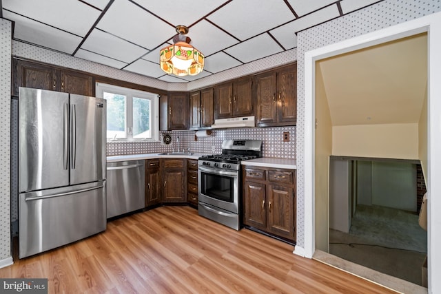 411 Parkstone Way, Broomall, PA 19008 - kitchen featuring appliances with stainless steel finishes, dark brown cabinetry, light countertops, under cabinet range hood, and light wood finished floors