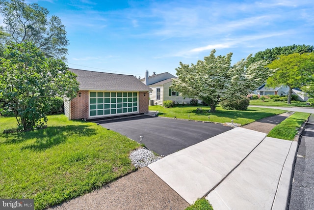 411 Parkstone Way, Broomall, PA 19008 - view of front of home with brick siding, a garage, a front lawn, and a shingled roof
