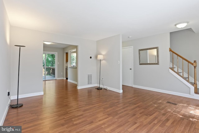7547 Filbert Ter, Gaithersburg, MD 20879 - unfurnished living room featuring wood finished floors and stairs