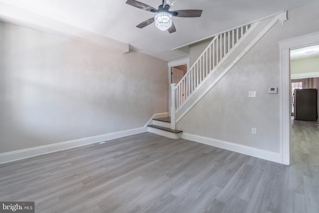 3335 Dudley Ave, Baltimore, MD 21213 - unfurnished living room with ceiling fan, stairs, and wood finished floors