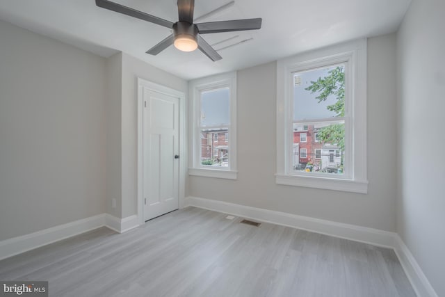 3335 Dudley Ave, Baltimore, MD 21213 - spare room with light wood-type flooring, healthy amount of natural light, and a ceiling fan
