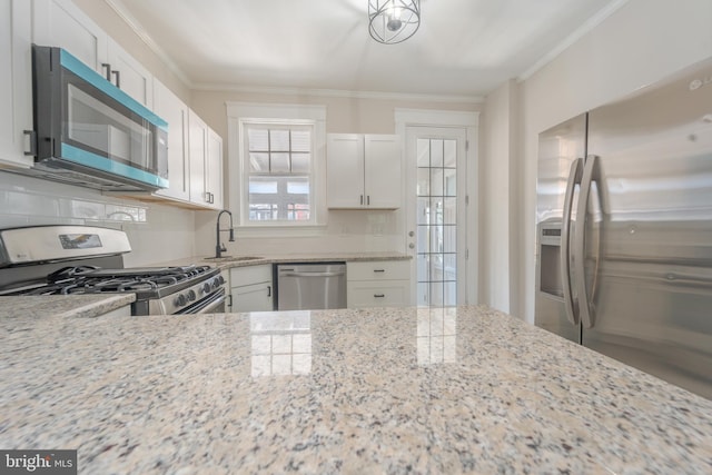 3335 Dudley Ave, Baltimore, MD 21213 - kitchen with appliances with stainless steel finishes, light stone countertops, tasteful backsplash, white cabinets, and ornamental molding