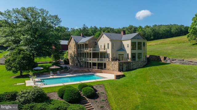 5751 Mount Pisgah Rd, York, PA 17406 - rear view of property featuring stone siding, an outdoor pool, a patio, a chimney, and a lawn